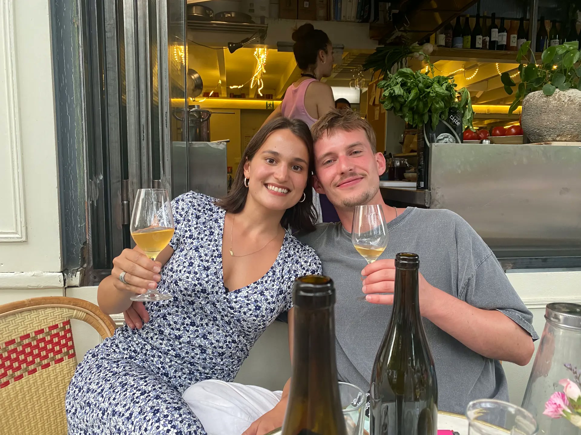 Zoe & Pete toasting with glasses of orange wine