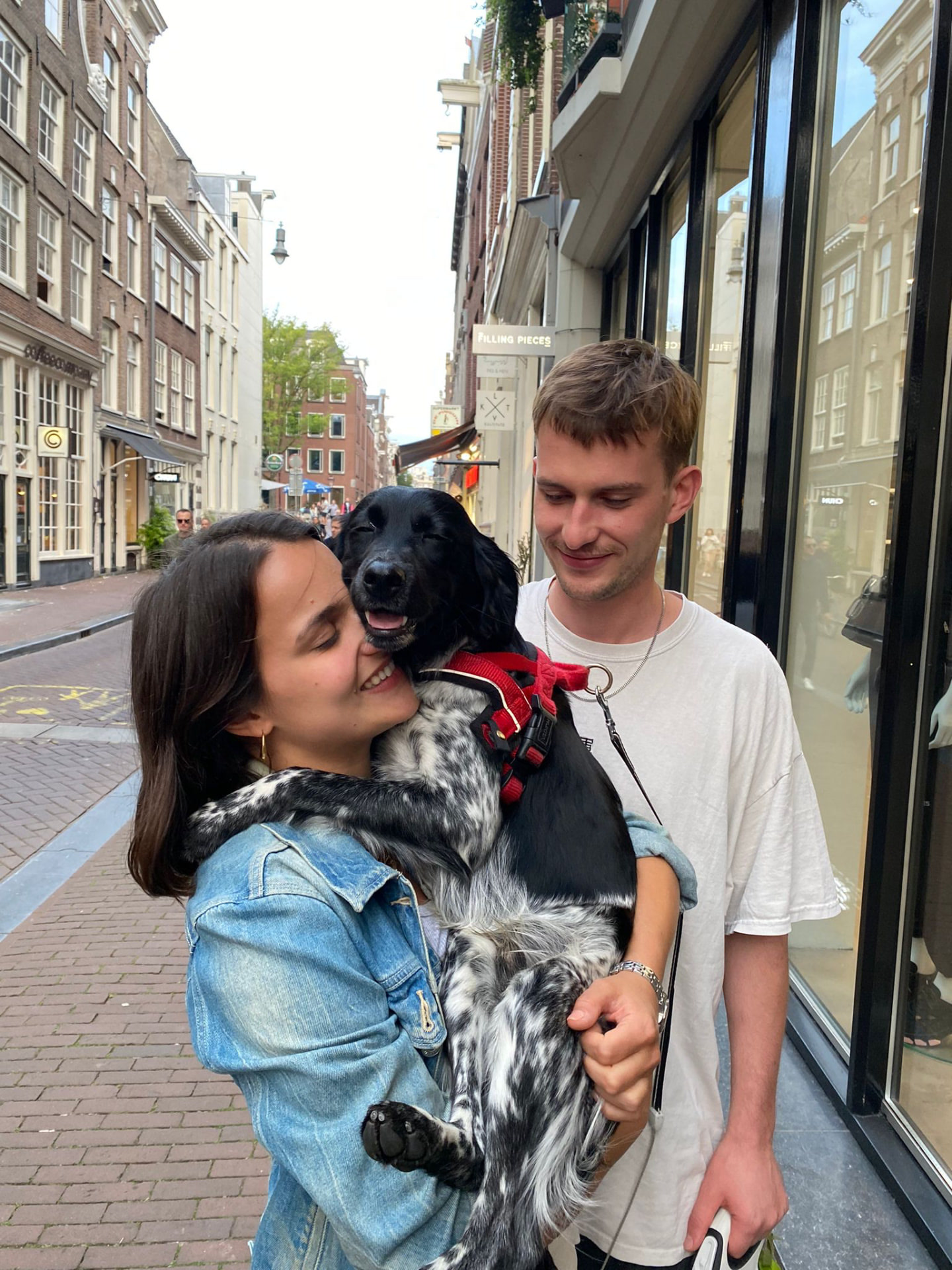 Zoe & Pete hugging their dog on an Amsterdam street