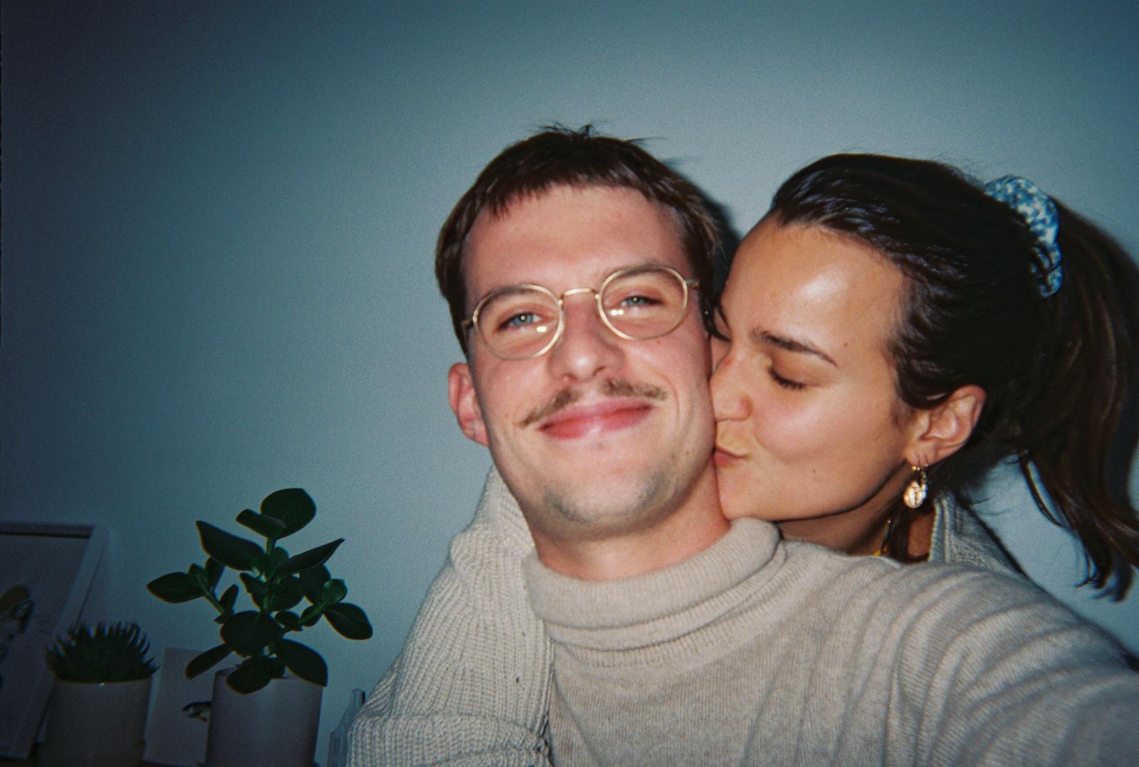 Zoe kissing Pete on the cheek at home