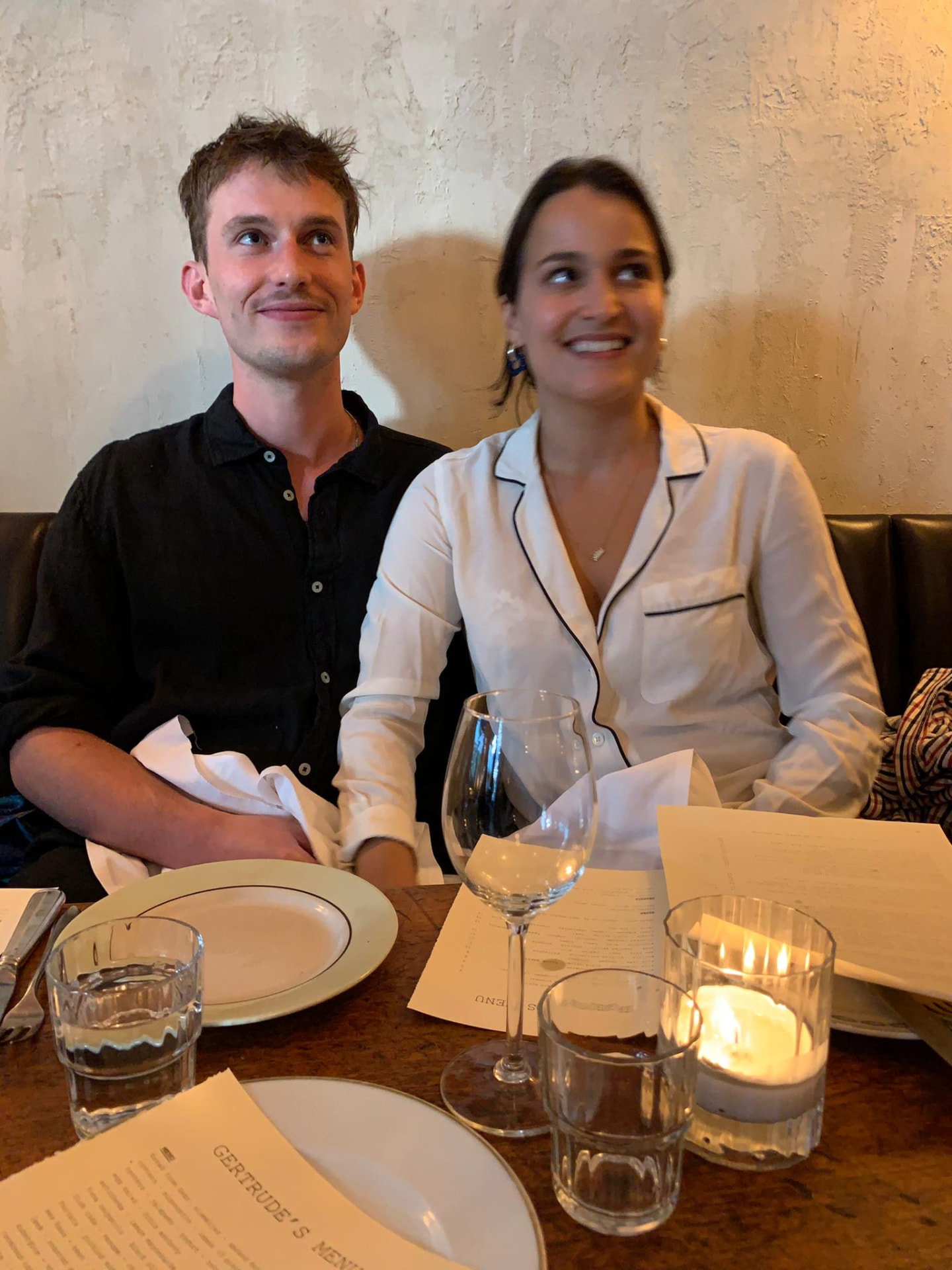 Zoe & Pete at dinner in a candlelit restaurant