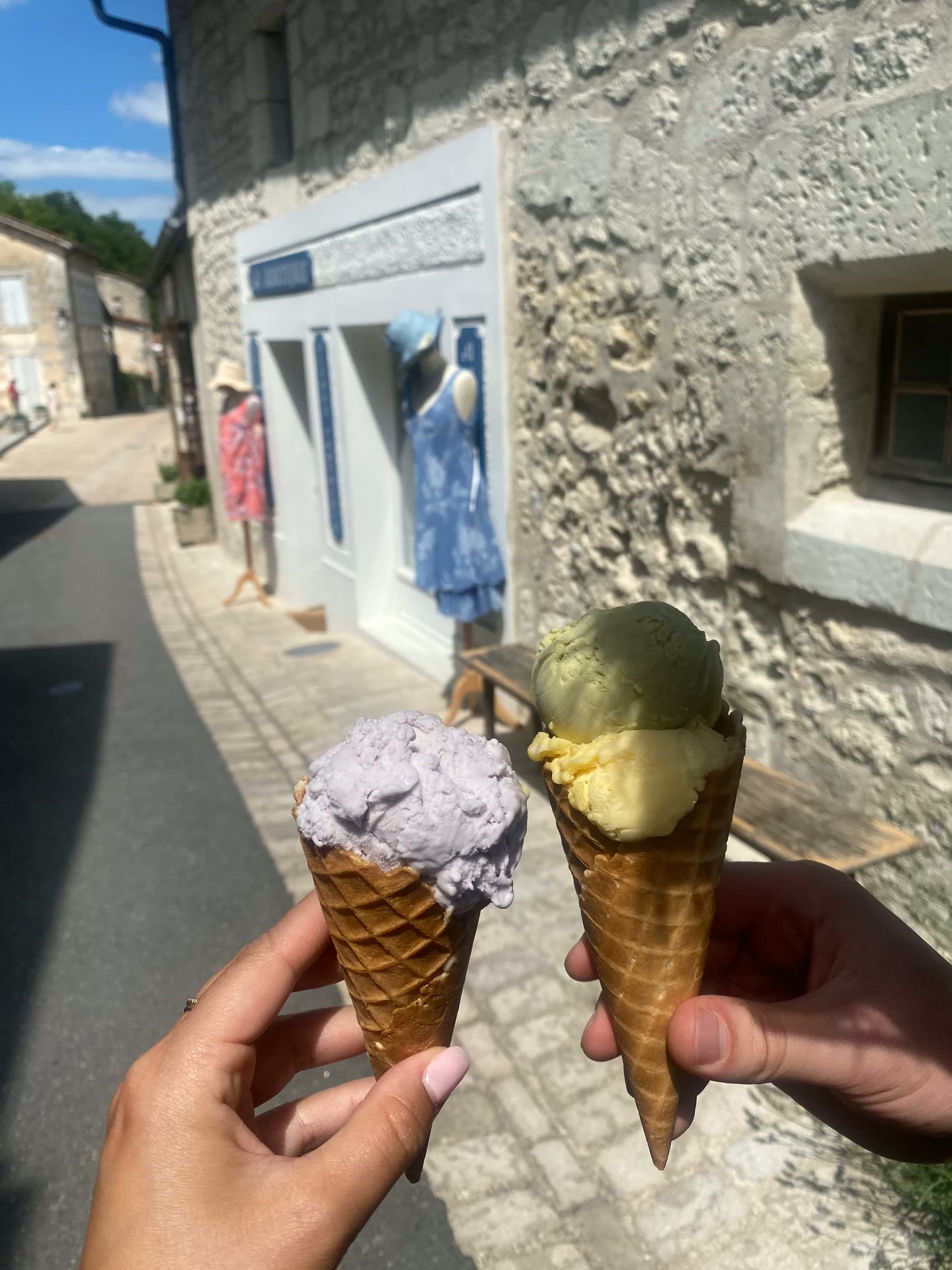 Two ice cream cones on a sunny village street