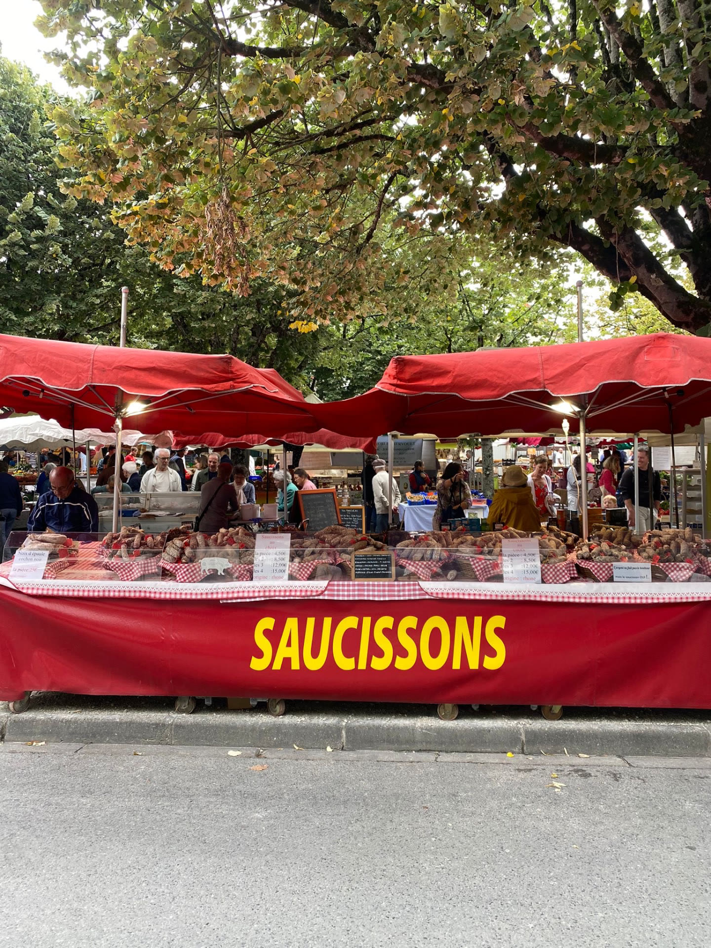 A red saucissons stall at a French market