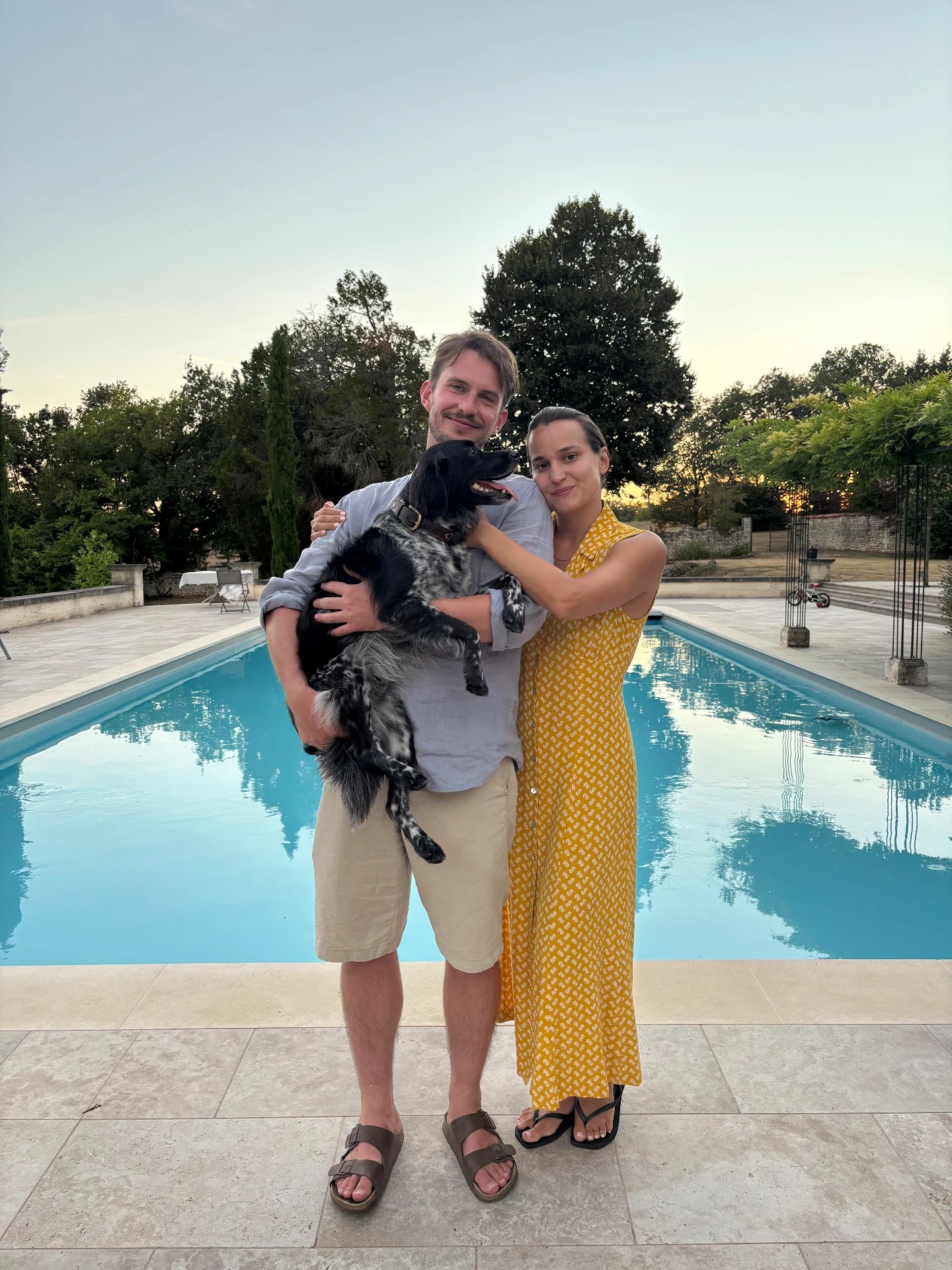 Zoe & Pete with their dog beside the pool