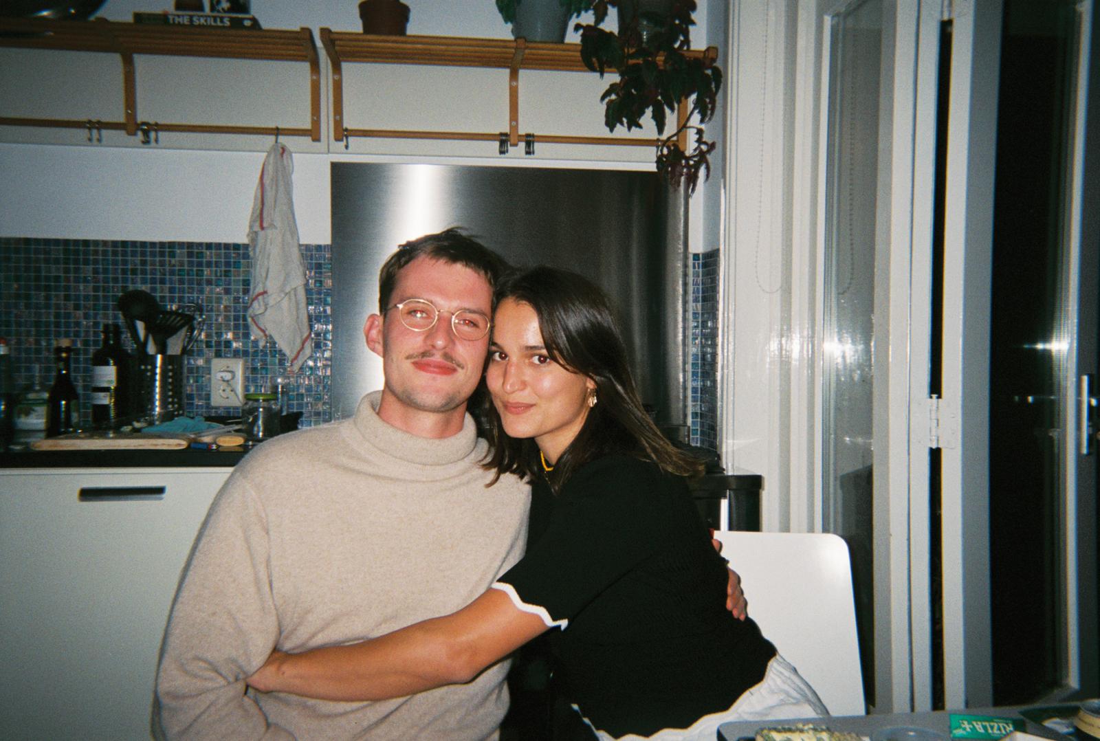 Zoe & Pete hugging in their kitchen