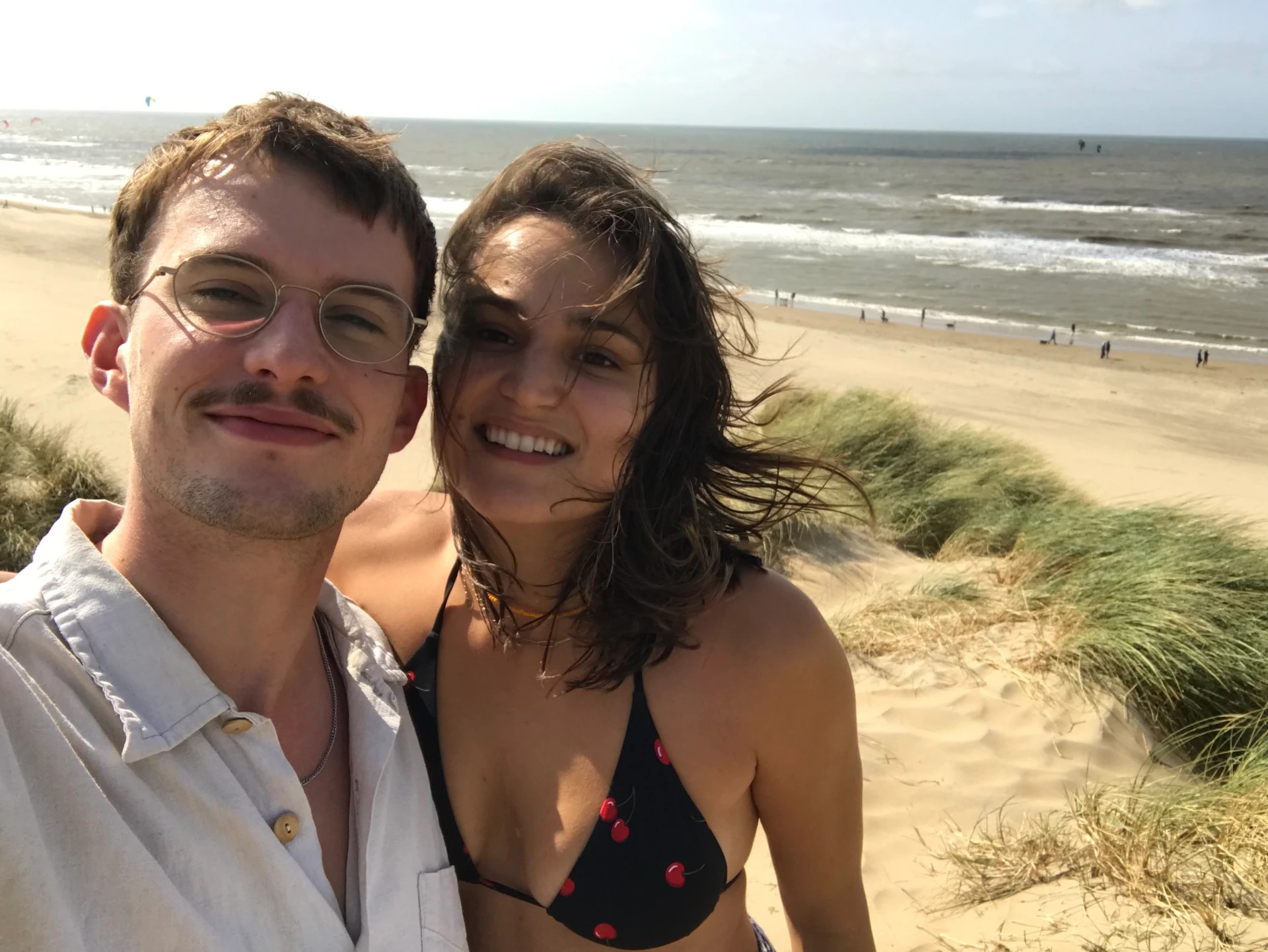 Zoe & Pete smiling together by the sea